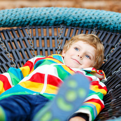 Obraz premium Little kid boy having fun on autumn playground