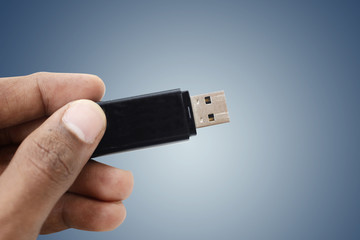 man hand holding up a flash drive