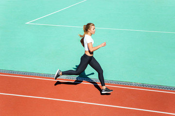 Fitness woman running at stadium