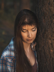 Young girl with long hair in the summer forest