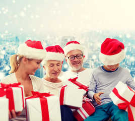 happy family in santa helper hats with gift boxes