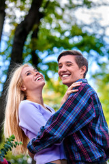 Young couple hugging and flirting in  park.