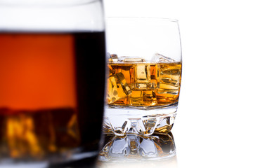 Glass of whiskey with ice isolated on white