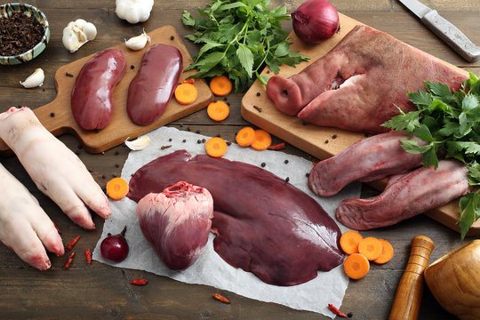 carne cruda frattaglie di maiale assortite su tavolo rustico