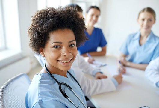 Happy Doctor Over Group Of Medics At Hospital