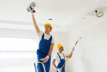 group of builders with tools indoors