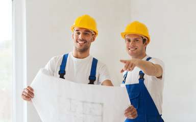 group of builders with blueprint