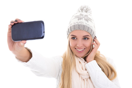 cute beautiful woman in winter clothes taking selfie photo with