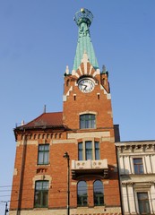 old building with high clock tower in center of Krakow
