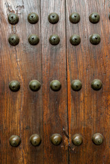 door with bronze clinches in the historical quarter of Caceres, Spain