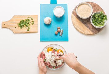 Good-looking female hands while preparing delicious traditional italian meatballs