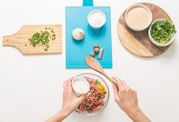 Good-looking female hands while preparing delicious traditional italian meatballs