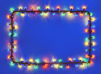 Christmas lights frame on dark blue background