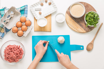 Good-looking female hands while preparing delicious traditional italian meatballs