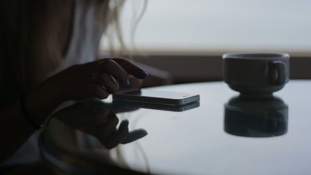close up hands of young beautiful girl sits in a cafe with