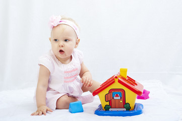 baby is playing with toys over white background
