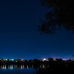 Stars in the night sky on a background city lighting. 