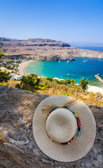 Straw hat on Lindos castle wall with beautiful view