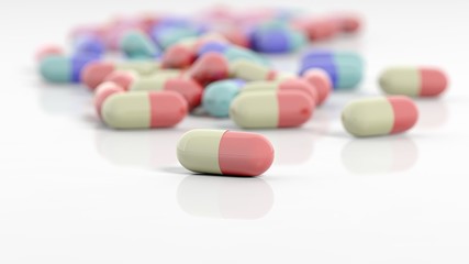 Colorful caplets with depth of field, on white background.