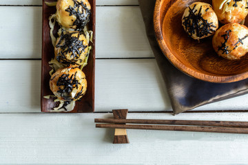 takoyaki on wooden table with chopsticks, Japanese food