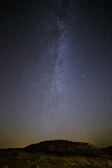 Starry sky and Milky Way on a background of hill.