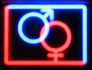 Abstract defocused blurred red and blue neon sign at the entranc
