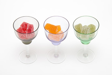 colors marmalade in wineglass on white  backgrounds