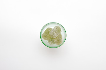 green marmalade in green wineglass on white