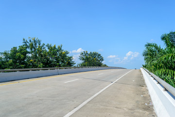 Asphalt road High way Empty curved road clouds and sky