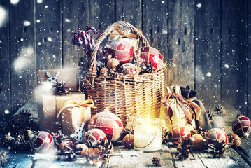 Christmas Gifts in Basket and Burning Candle. Vintage style