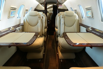 rear part of business jet cabin with open tables