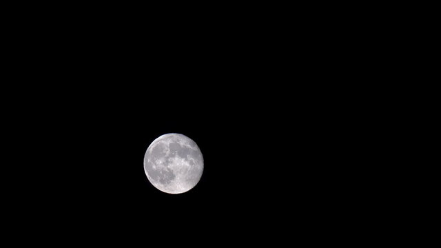Full moon time lapse across dark sky 4K 151
