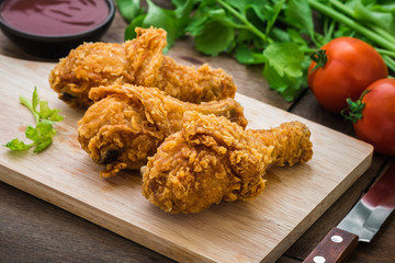 Crispy fried chicken on wooden cutting board and dip sauce