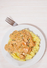 chicken breast in a creamy sauce with mashed potatoes