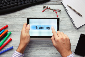 Businessmen using touchpad. Pressing Training button.