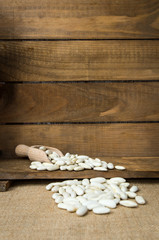 Obraz na płótnie Canvas White beans on wooden table