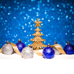 Fototapeta na wymiar christmas ornament in snow on glitter background