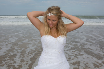 Fototapeta na wymiar Bride at the beach with a wedding clothes