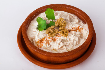 chicken in a creamy sauce with parsley and walnuts pot white