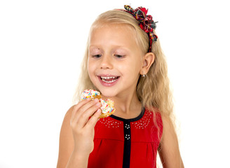 little beautiful female child with long blonde hair and red dress eating sugar donut with toppings delighted and happy