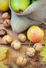 Autumn composition of fruits, nuts and spices - pears, walnuts, maple leaves