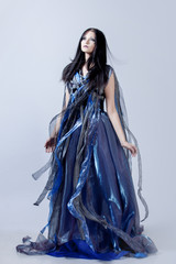 Naklejka premium Fashion photo of young magnificent woman in blue dress. Studio