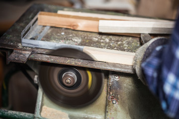 Old carpenter working with wood