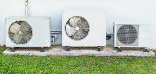 Fototapeta premium Three old air conditioner beside home