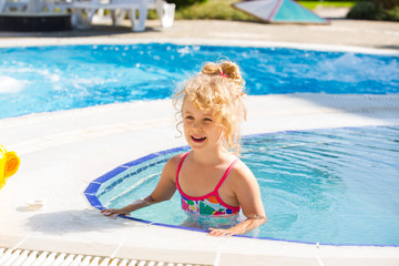 Happy little girl in the pool