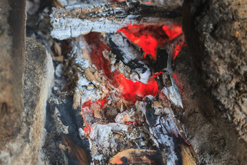 bonfire with orange flames and firewood