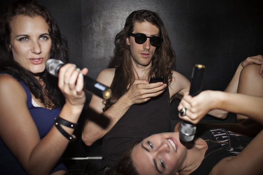 Friends doing karaoke at a nightclub