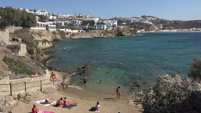 Mykonos Greece sandy beach along coastal cliff 4K 154