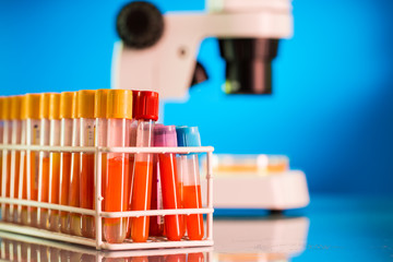 Laboratory work place with microscope, test tube and pipettes.