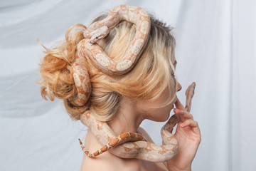 Beautiful girl and the snake Boa constrictors, which wraps